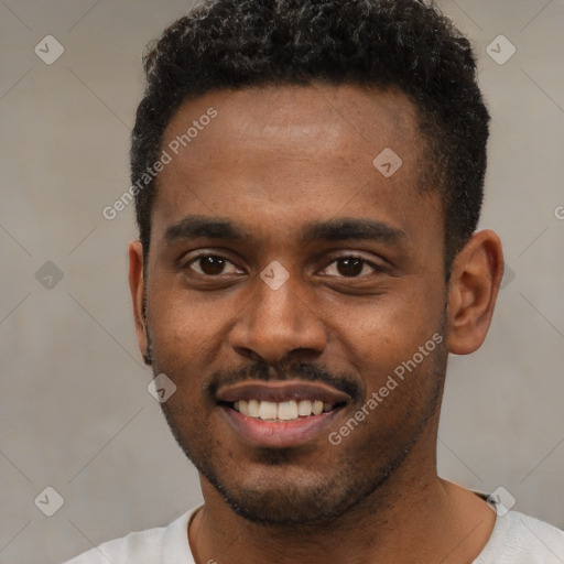 Joyful black young-adult male with short  brown hair and brown eyes