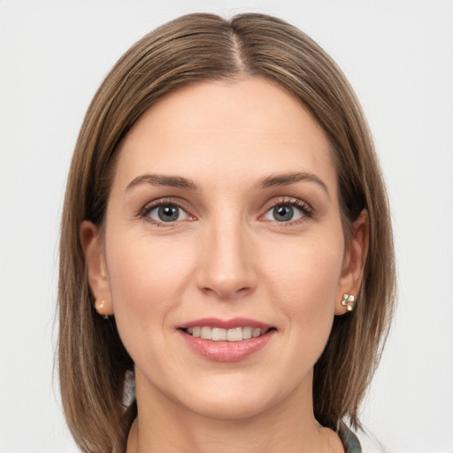 Joyful white young-adult female with long  brown hair and grey eyes