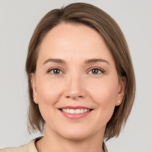 Joyful white young-adult female with medium  brown hair and brown eyes