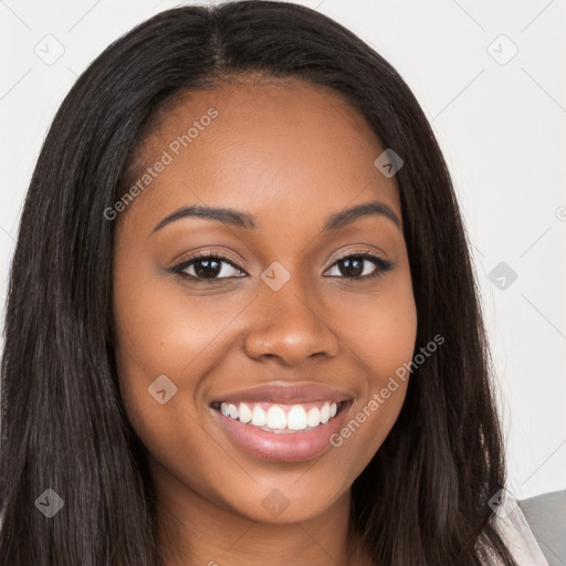 Joyful black young-adult female with long  brown hair and brown eyes