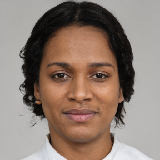 Joyful black young-adult female with medium  black hair and brown eyes
