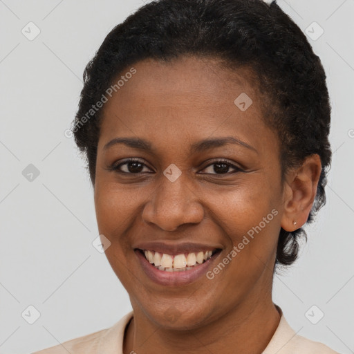 Joyful black young-adult female with short  brown hair and brown eyes