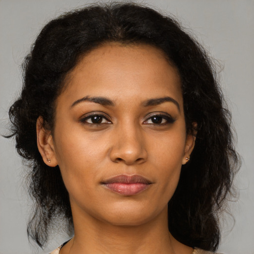 Joyful black young-adult female with medium  brown hair and brown eyes