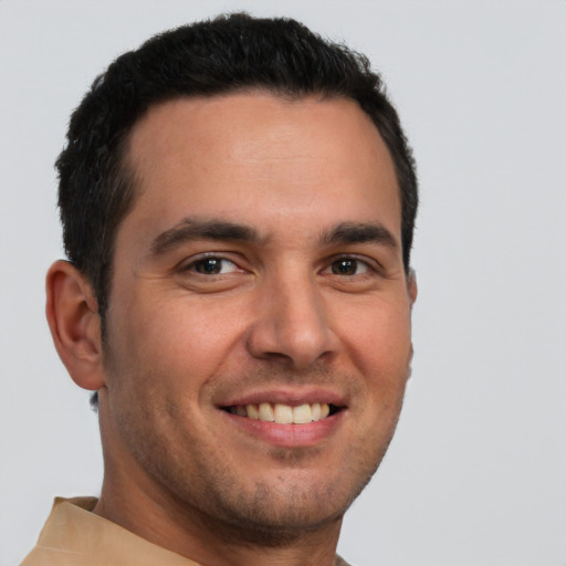 Joyful white young-adult male with short  brown hair and brown eyes