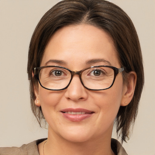 Joyful white adult female with medium  brown hair and brown eyes