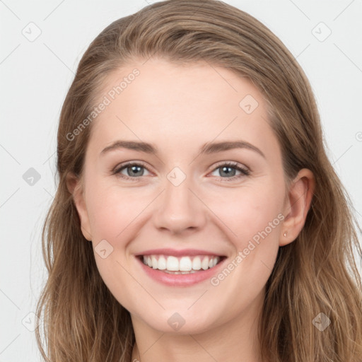 Joyful white young-adult female with long  brown hair and grey eyes