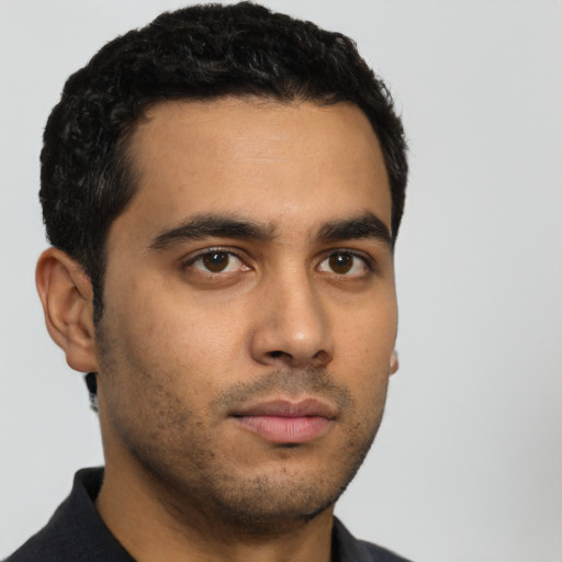Neutral latino young-adult male with short  black hair and brown eyes