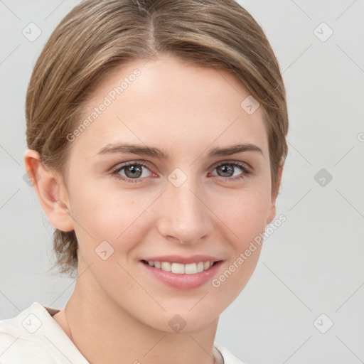 Joyful white young-adult female with medium  brown hair and grey eyes