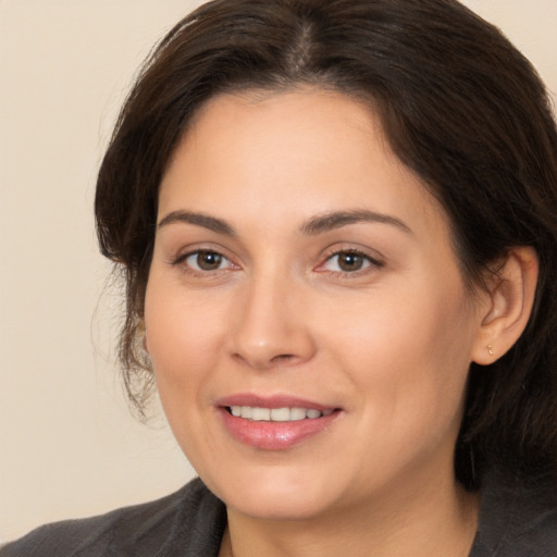 Joyful white young-adult female with medium  brown hair and brown eyes