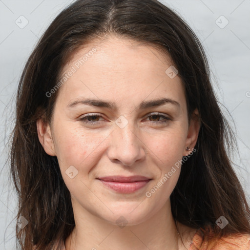 Joyful white adult female with long  brown hair and brown eyes