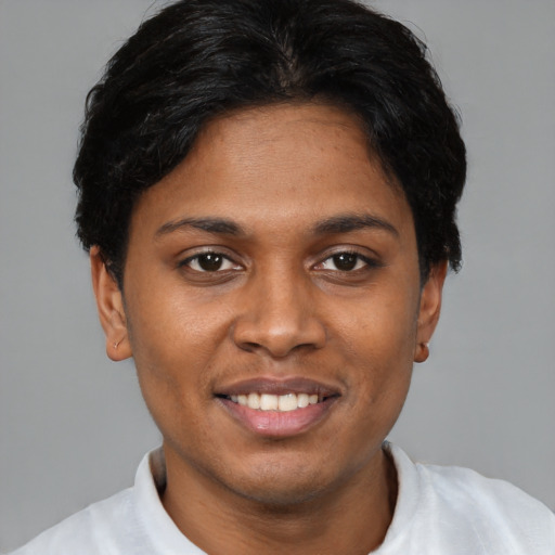 Joyful black young-adult female with short  brown hair and brown eyes