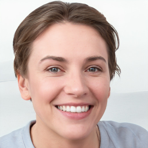 Joyful white young-adult female with short  brown hair and grey eyes