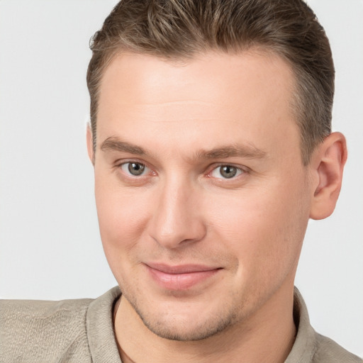 Joyful white young-adult male with short  brown hair and brown eyes