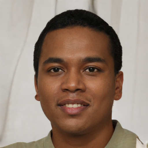 Joyful black young-adult male with short  black hair and brown eyes