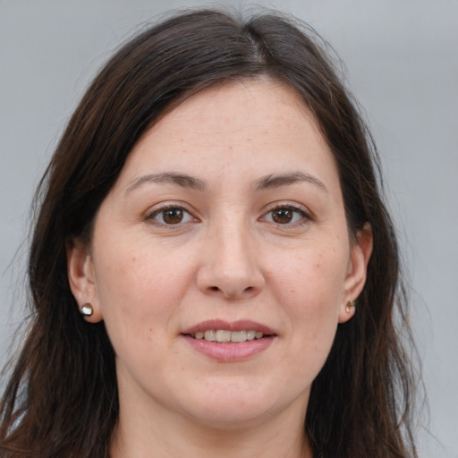 Joyful white adult female with long  brown hair and brown eyes