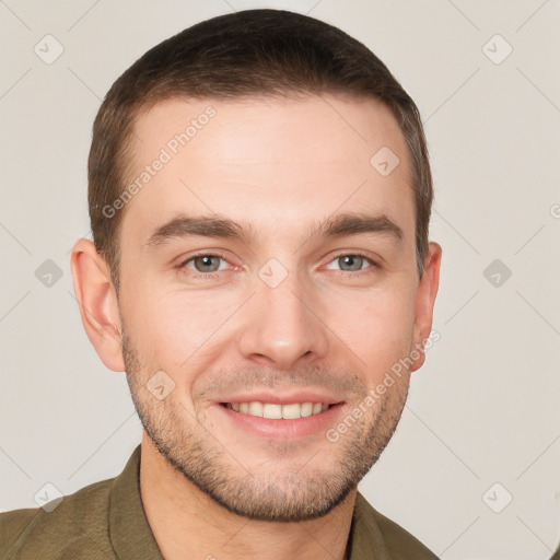 Joyful white young-adult male with short  brown hair and grey eyes