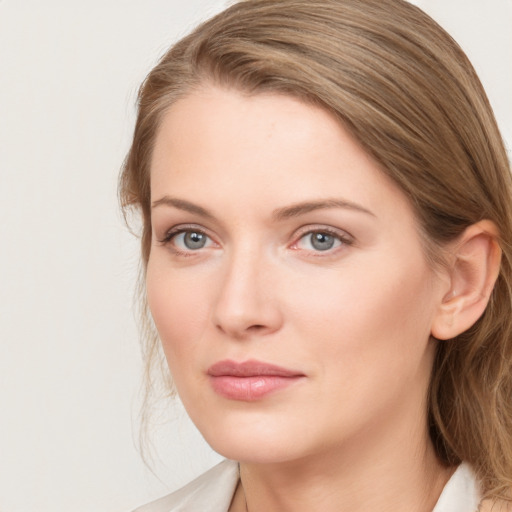 Joyful white young-adult female with long  brown hair and blue eyes