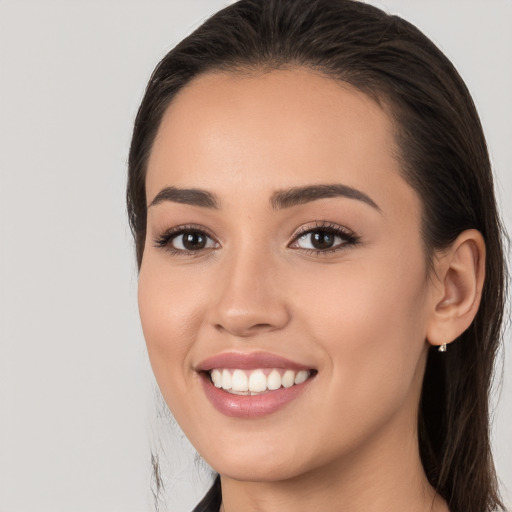 Joyful white young-adult female with long  brown hair and brown eyes