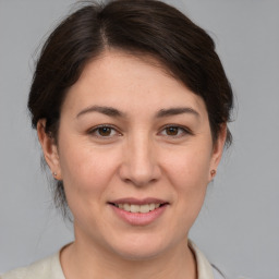 Joyful white adult female with medium  brown hair and brown eyes