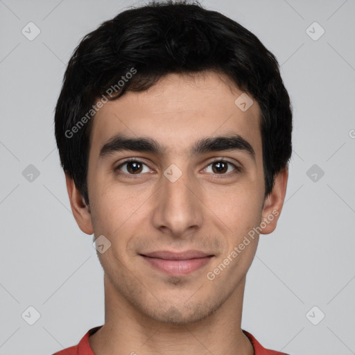 Joyful white young-adult male with short  black hair and brown eyes