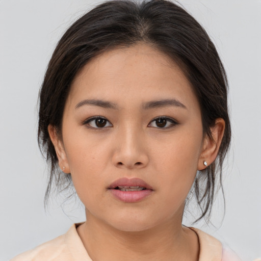 Neutral asian young-adult female with medium  brown hair and brown eyes