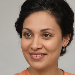 Joyful white adult female with medium  brown hair and brown eyes