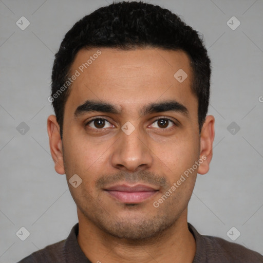 Joyful latino young-adult male with short  black hair and brown eyes