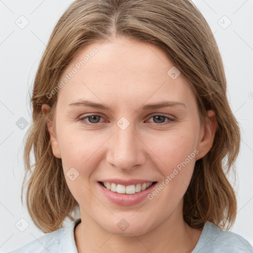 Joyful white young-adult female with medium  brown hair and blue eyes