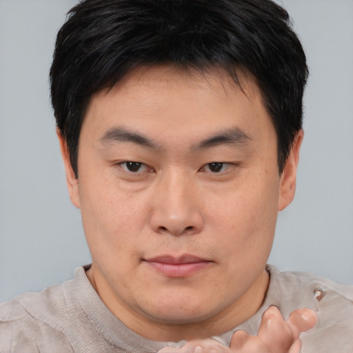 Neutral asian young-adult male with short  brown hair and brown eyes