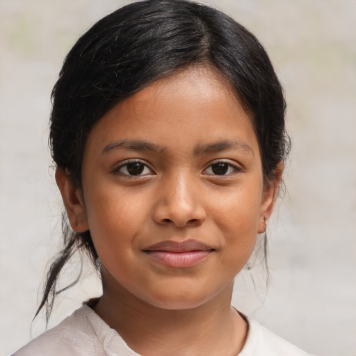 Joyful latino child female with medium  brown hair and brown eyes