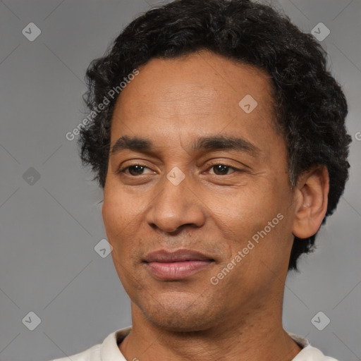 Joyful latino adult male with short  brown hair and brown eyes