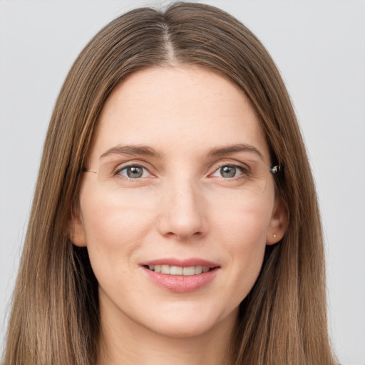 Joyful white young-adult female with long  brown hair and grey eyes