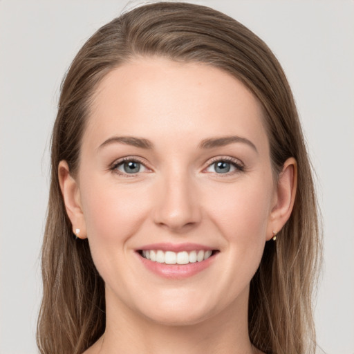 Joyful white young-adult female with long  brown hair and grey eyes