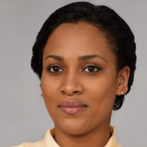 Joyful black young-adult female with short  brown hair and brown eyes