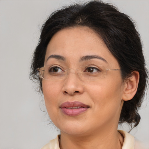 Joyful latino adult female with medium  brown hair and brown eyes