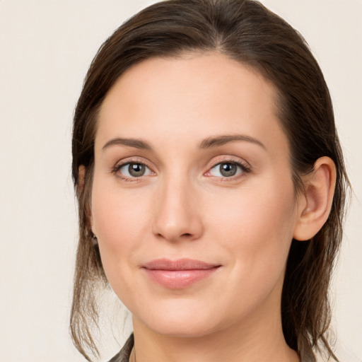 Joyful white young-adult female with long  brown hair and grey eyes