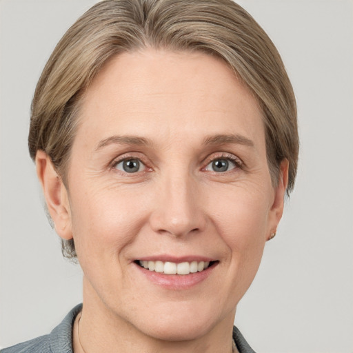 Joyful white adult female with short  brown hair and grey eyes