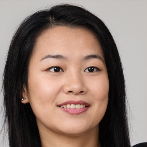 Joyful asian young-adult female with long  brown hair and brown eyes