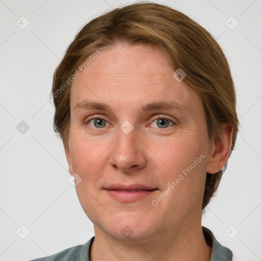 Joyful white adult female with medium  brown hair and blue eyes