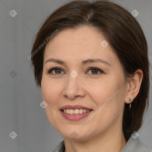 Joyful white adult female with medium  brown hair and brown eyes