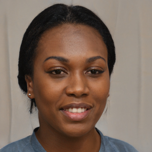 Joyful black young-adult female with medium  brown hair and brown eyes