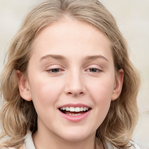 Joyful white young-adult female with medium  brown hair and blue eyes