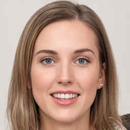 Joyful white young-adult female with long  brown hair and grey eyes