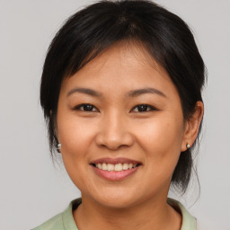 Joyful asian young-adult female with medium  brown hair and brown eyes