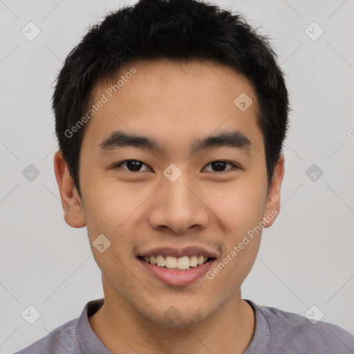 Joyful asian young-adult male with short  black hair and brown eyes