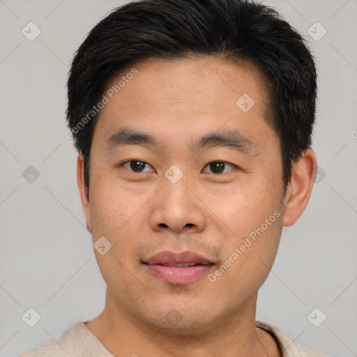 Joyful asian young-adult male with short  brown hair and brown eyes