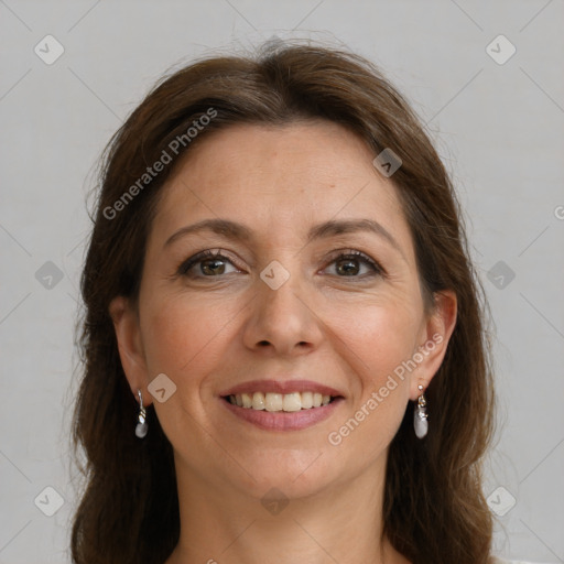 Joyful white adult female with long  brown hair and brown eyes