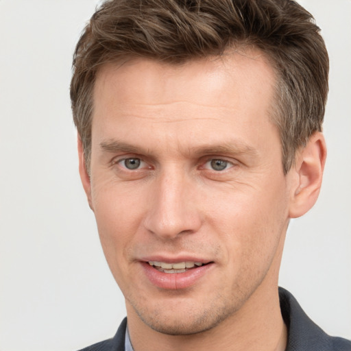 Joyful white adult male with short  brown hair and grey eyes