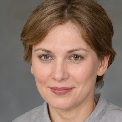 Joyful white adult female with medium  brown hair and brown eyes