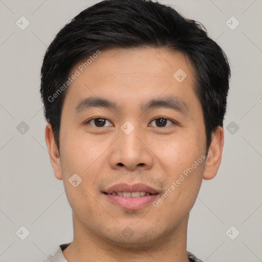 Joyful asian young-adult male with short  black hair and brown eyes